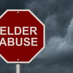 stop sign with elder abuse written on it